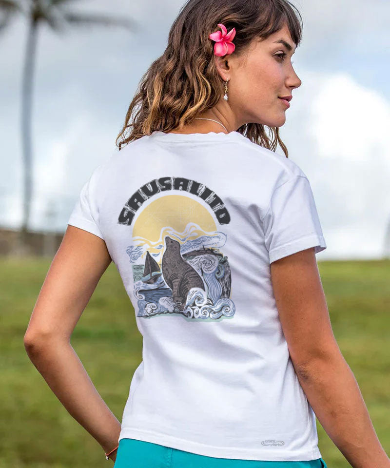 Woman wearing a white t-shirt with a graphic design and text, standing outdoors. View 2