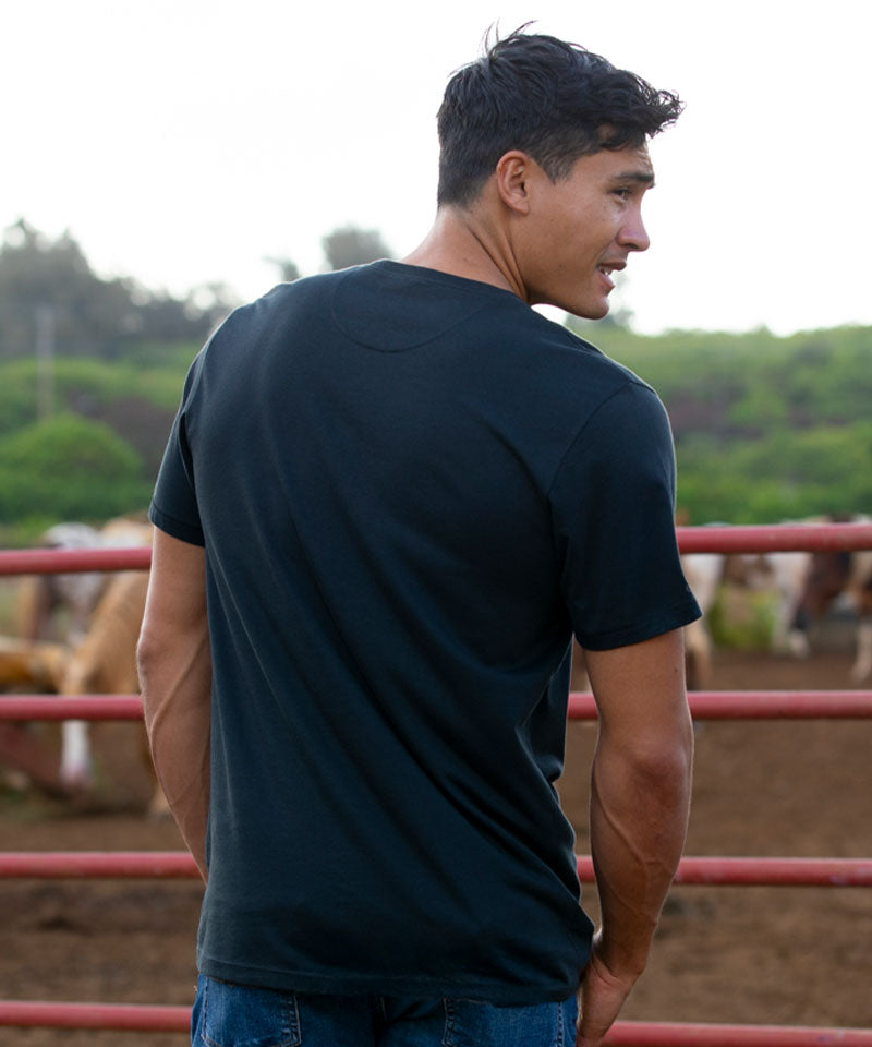 Man wearing a black t-shirt standing in an outdoor setting View 3