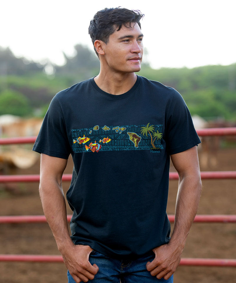 Man wearing a black t-shirt with a colorful graphic design outdoors. View 2