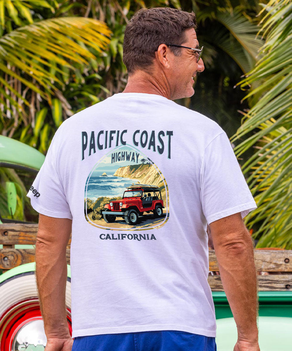 Man wearing a white t-shirt with a graphic design of a Jeep and text 'Pacific Coast Highway, California'. View 2