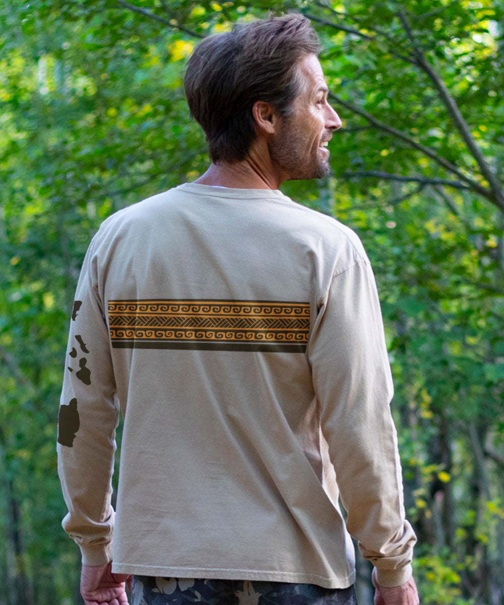 Man wearing a light brown long-sleeve shirt with a patterned design, standing outdoors View 3