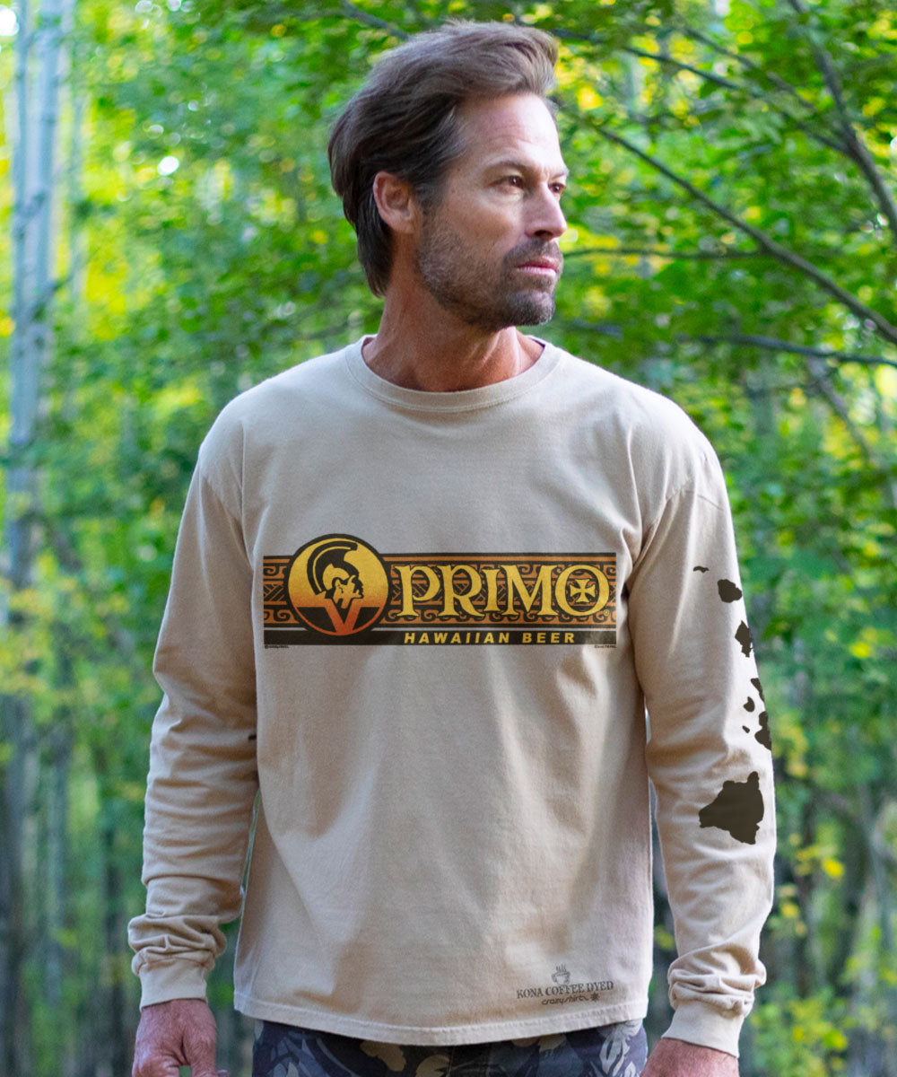 Man wearing a light brown long-sleeve shirt with 'Primo Hawaiian Beer' logo standing in a forest setting View 2