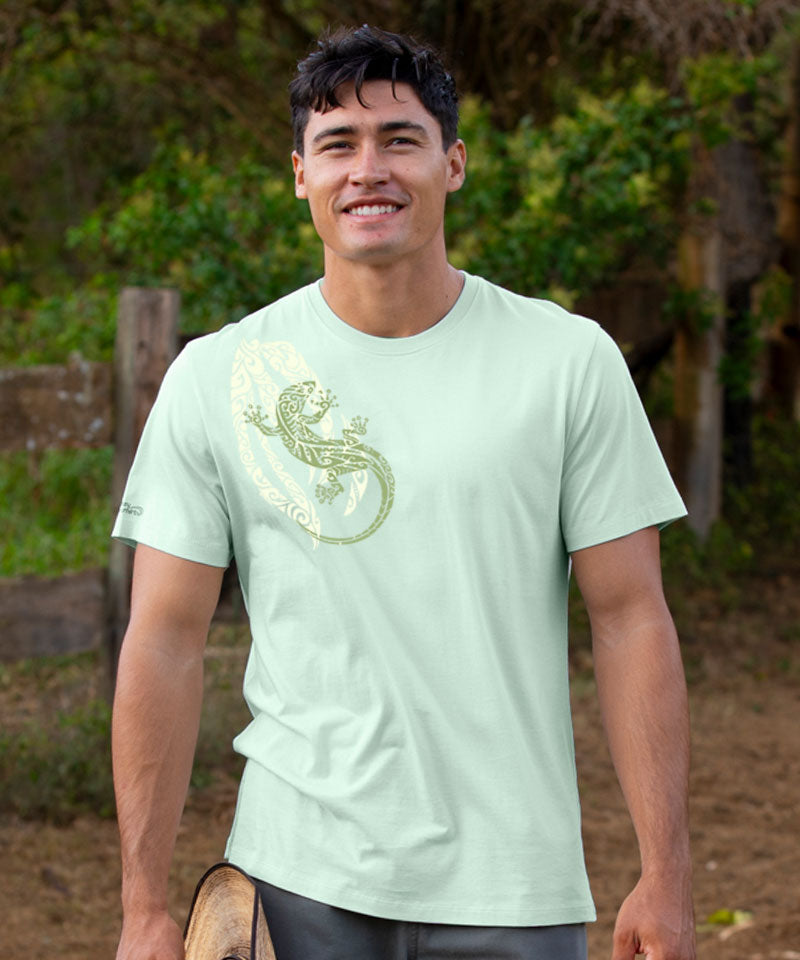 Man wearing a light green t-shirt with a graphic design outdoors View 2