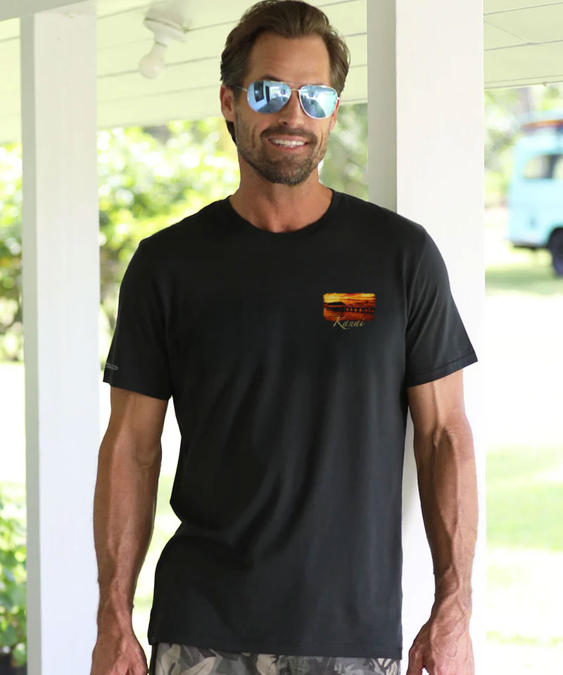 Man wearing a black t-shirt with a logo outdoors View 3