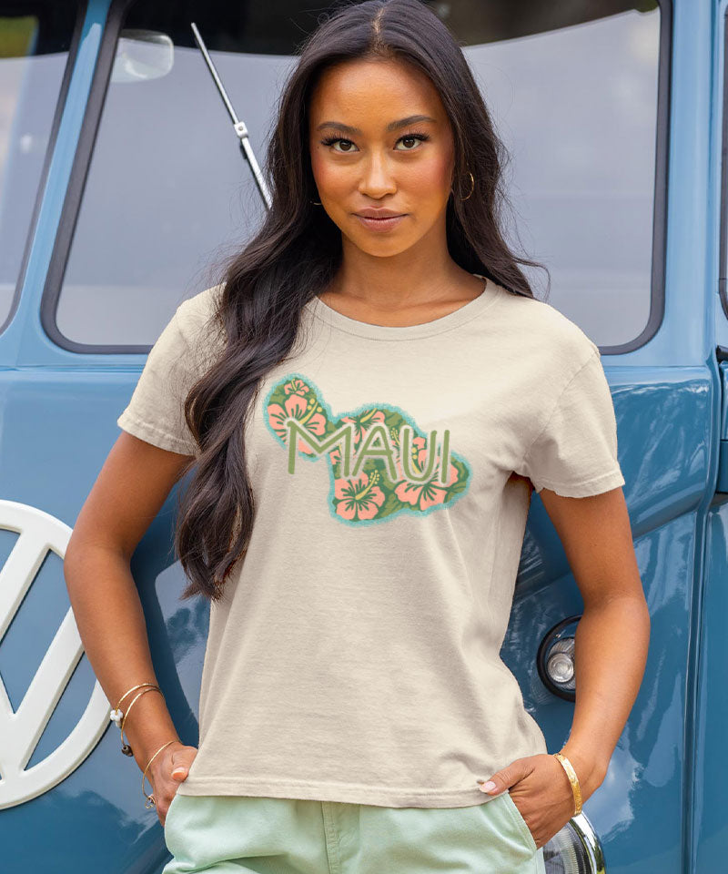 Woman wearing a 'Maui' t-shirt in front of a blue vehicle View 2