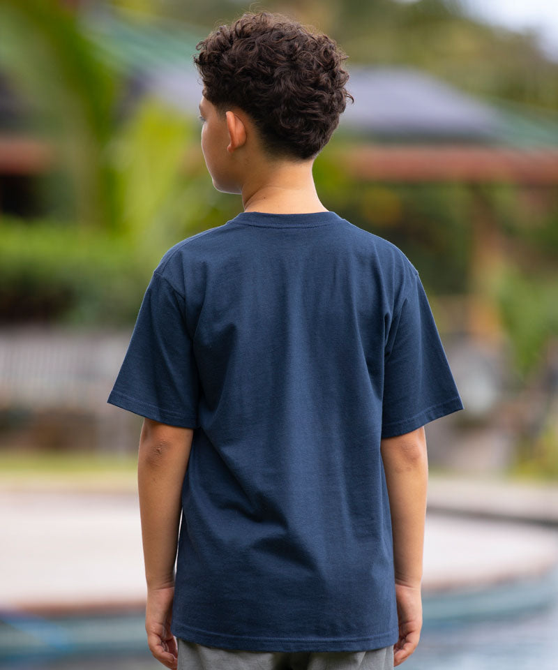 Young boy wearing a Navy t-shirt standing in front of a pool facing away from the camera View 3