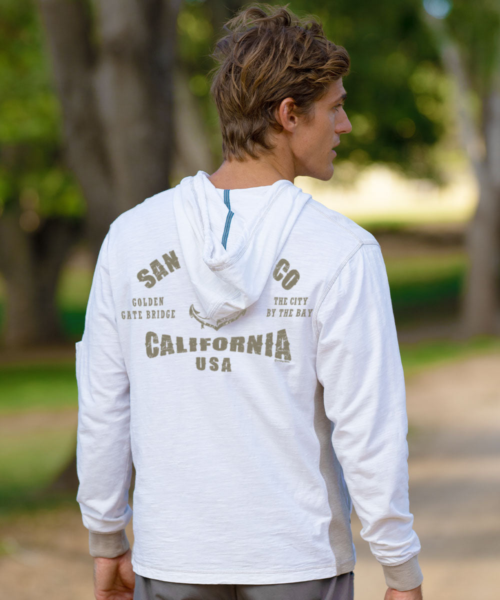 Man wearing a white jacket with a gray graphic standing outside View 2