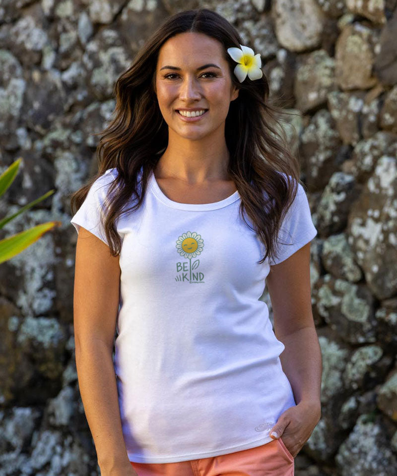 Woman wearing a white t-shirt with the words 'Be Kind' written on the front standing in front of a rock wall View 2