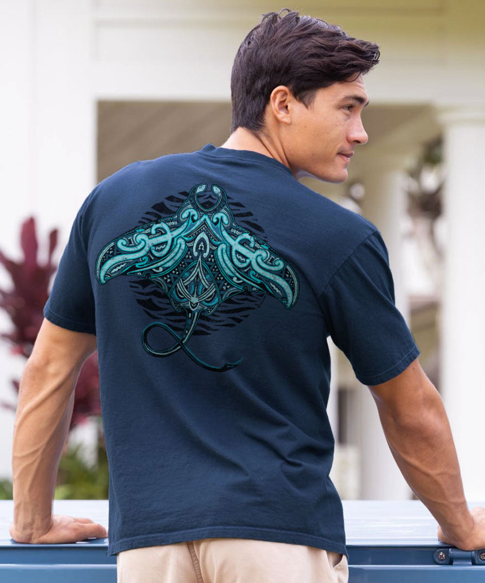 Man wearing a navy blue t-shirt with a teal graphic on the back, standing outdoors. View 2