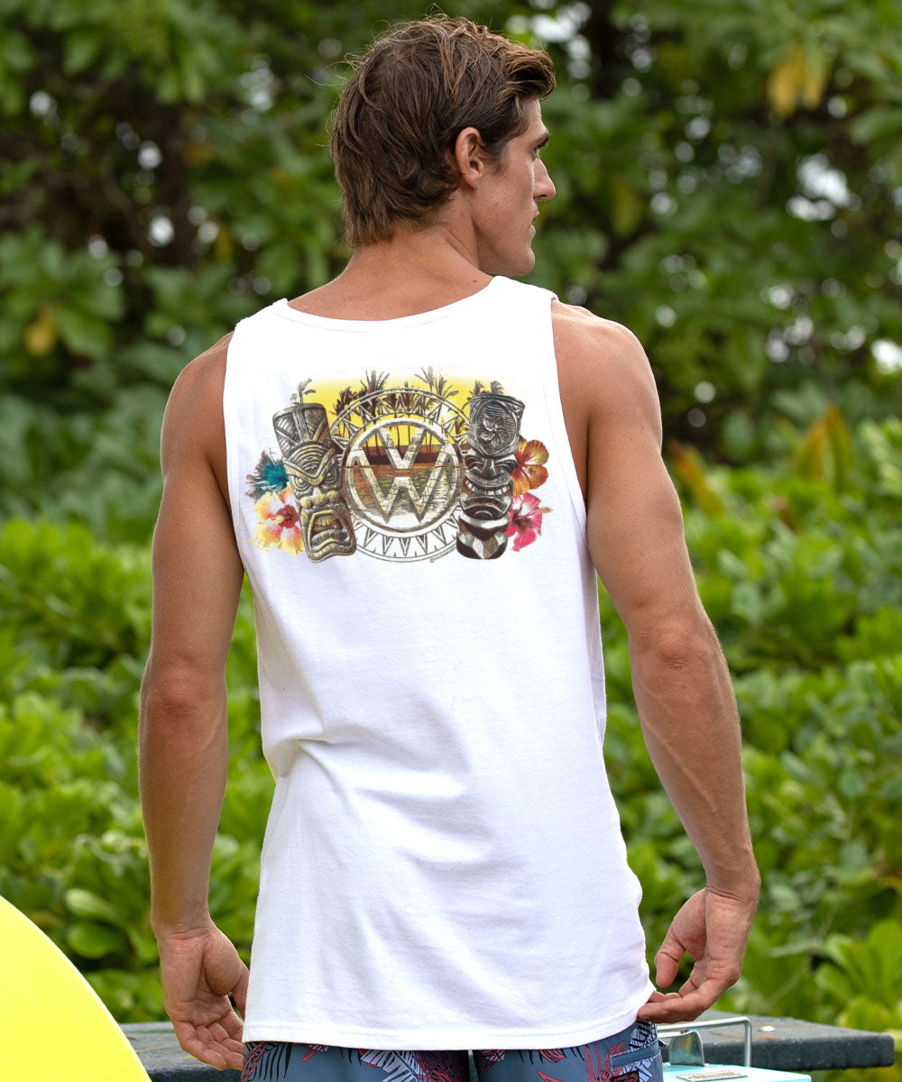 Man wearing a white tank top with a colorful graphic design outdoors. View 2
