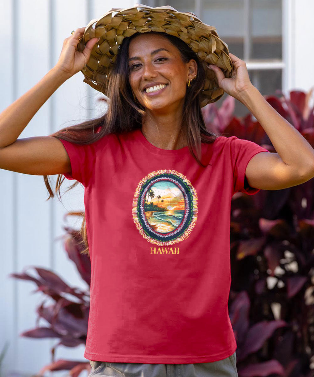 Woman wearing a raspberry dyed 'Hawaii' t-shirt with a scenic design, standing outdoors. View 2
