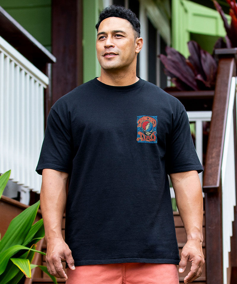 Man wearing a black t-shirt with a colorful graphic on a wooden deck View 3