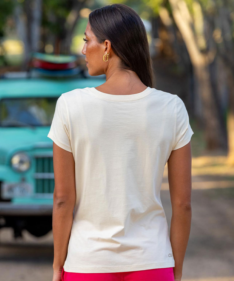 Woman standing outside in front of a vintage car wearing a sand colored tee View 3