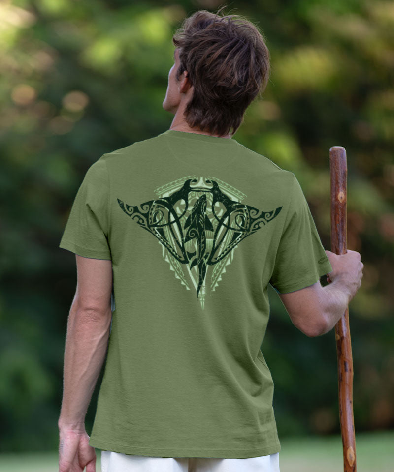 Person wearing a green t-shirt with a design on the back, standing outdoors. View 2