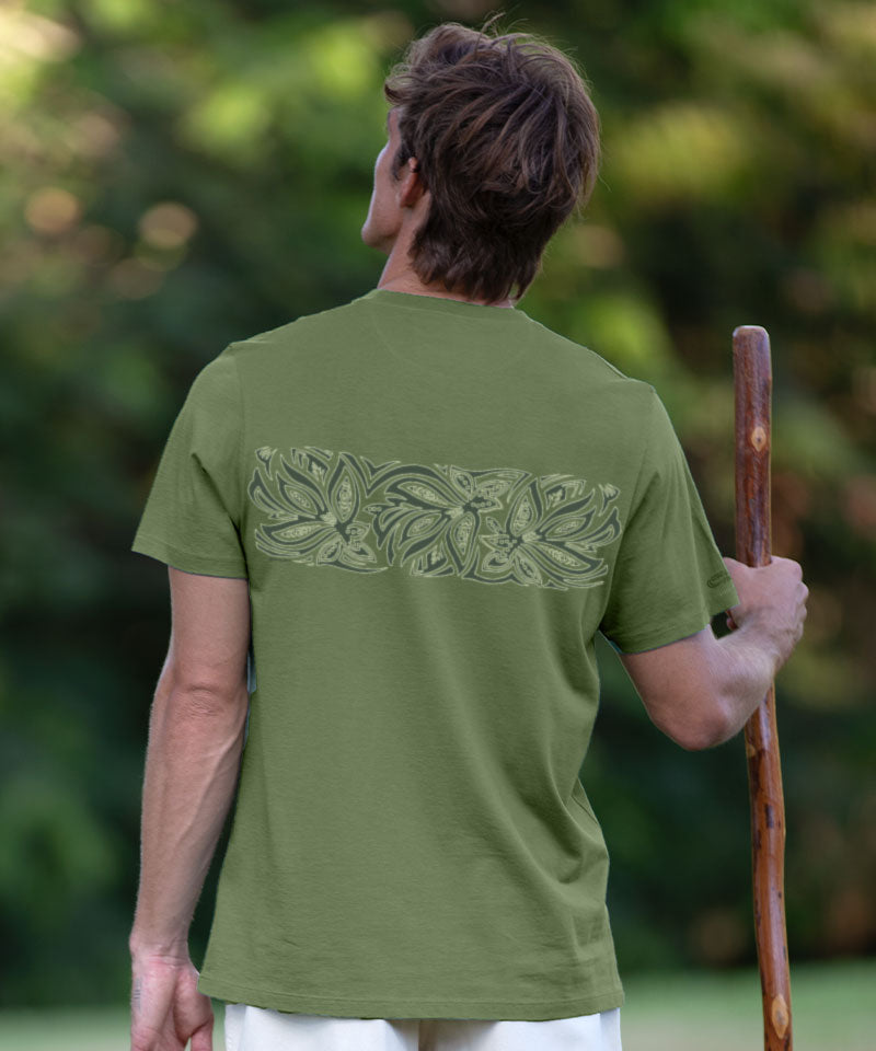Person wearing a green t-shirt with a leaf pattern on the back, standing outdoors. View 3