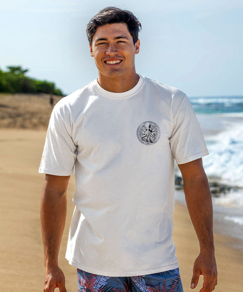 Man wearing a white t-shirt with a graphic design on a beach View 3