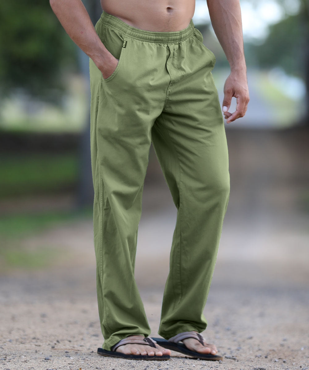 Person wearing green pants standing outdoors with a blurred background View 2