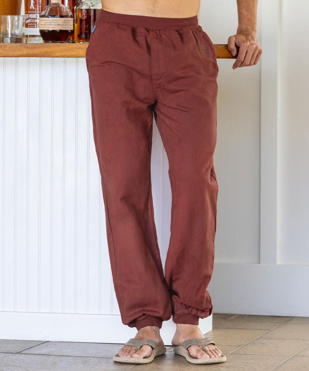 Person wearing reddish-brown pants standing in a kitchen. View 2