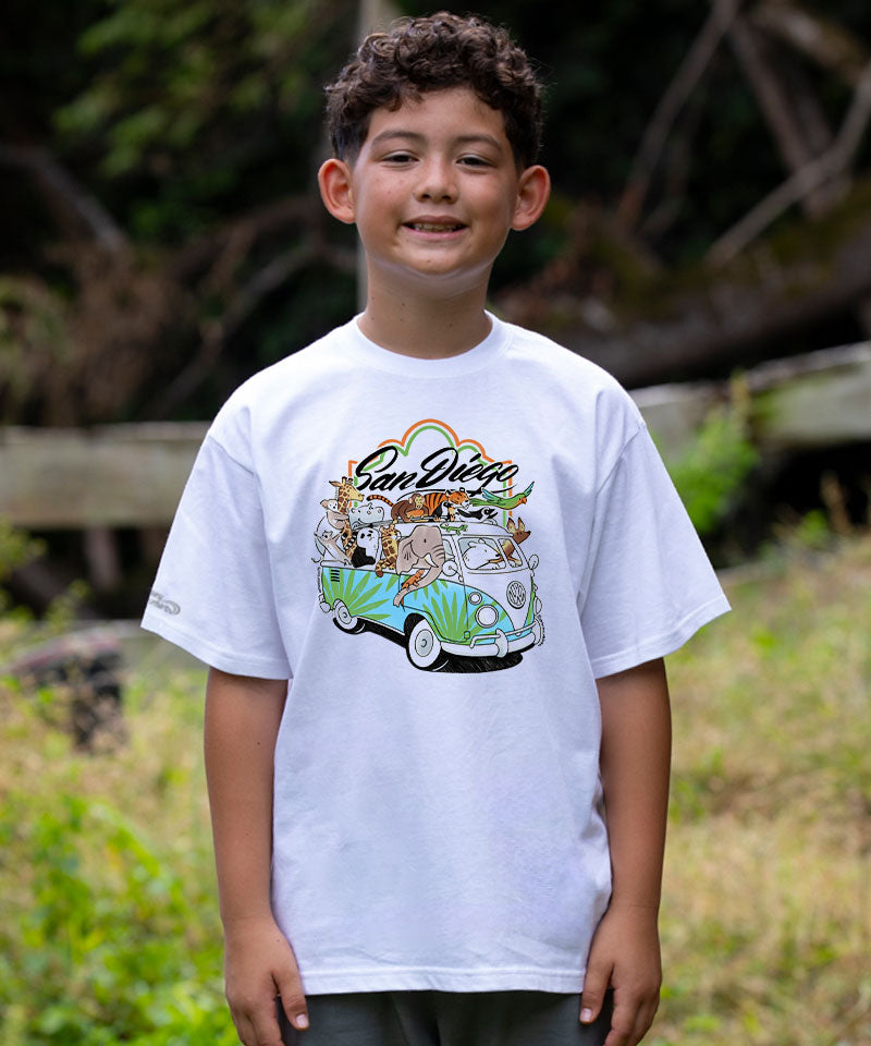 Child wearing a white t-shirt with a colorful graphic design outdoors View 2