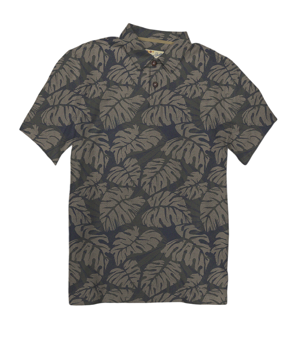 A short-sleeve polo shirt with an all-over tropical monstera leaf pattern in muted olive green and dark charcoal gray, shown flat against a plain white background. View 1