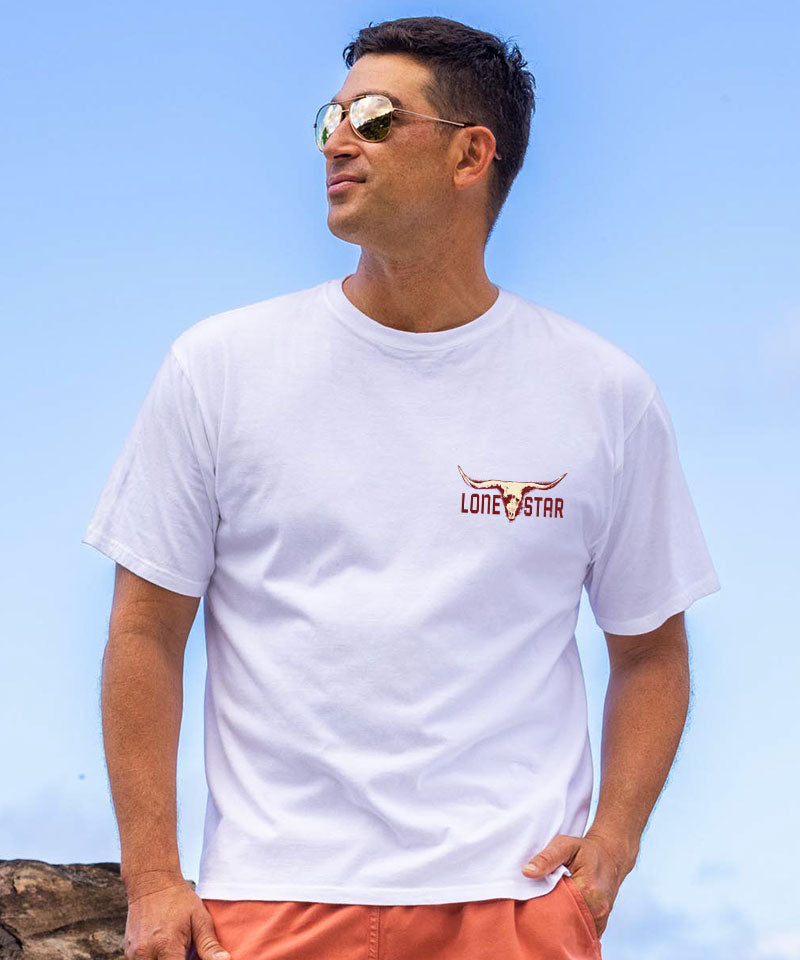 Man wearing a white t-shirt with a logo against a clear blue sky View 3