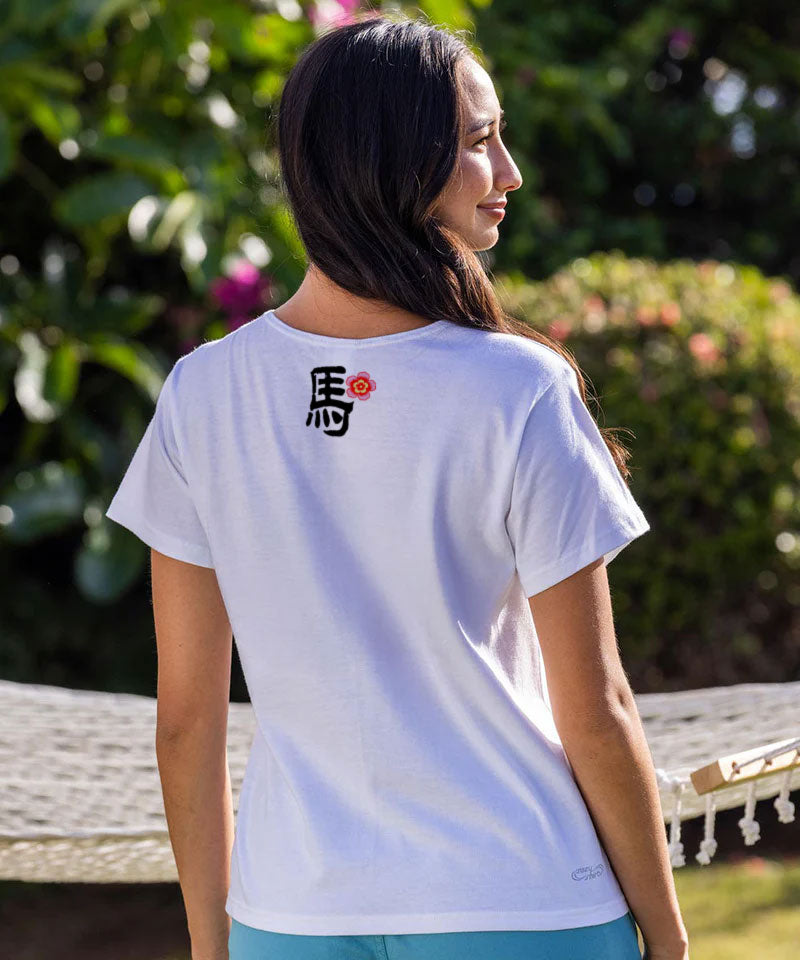 Person wearing a white t-shirt with black text and a red symbol outdoors. View 3