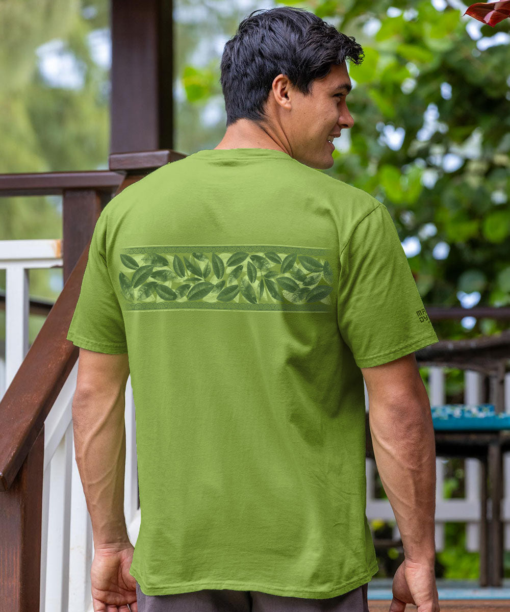 Man wearing a green t-shirt with leaf pattern on the back, standing outdoors. View 3