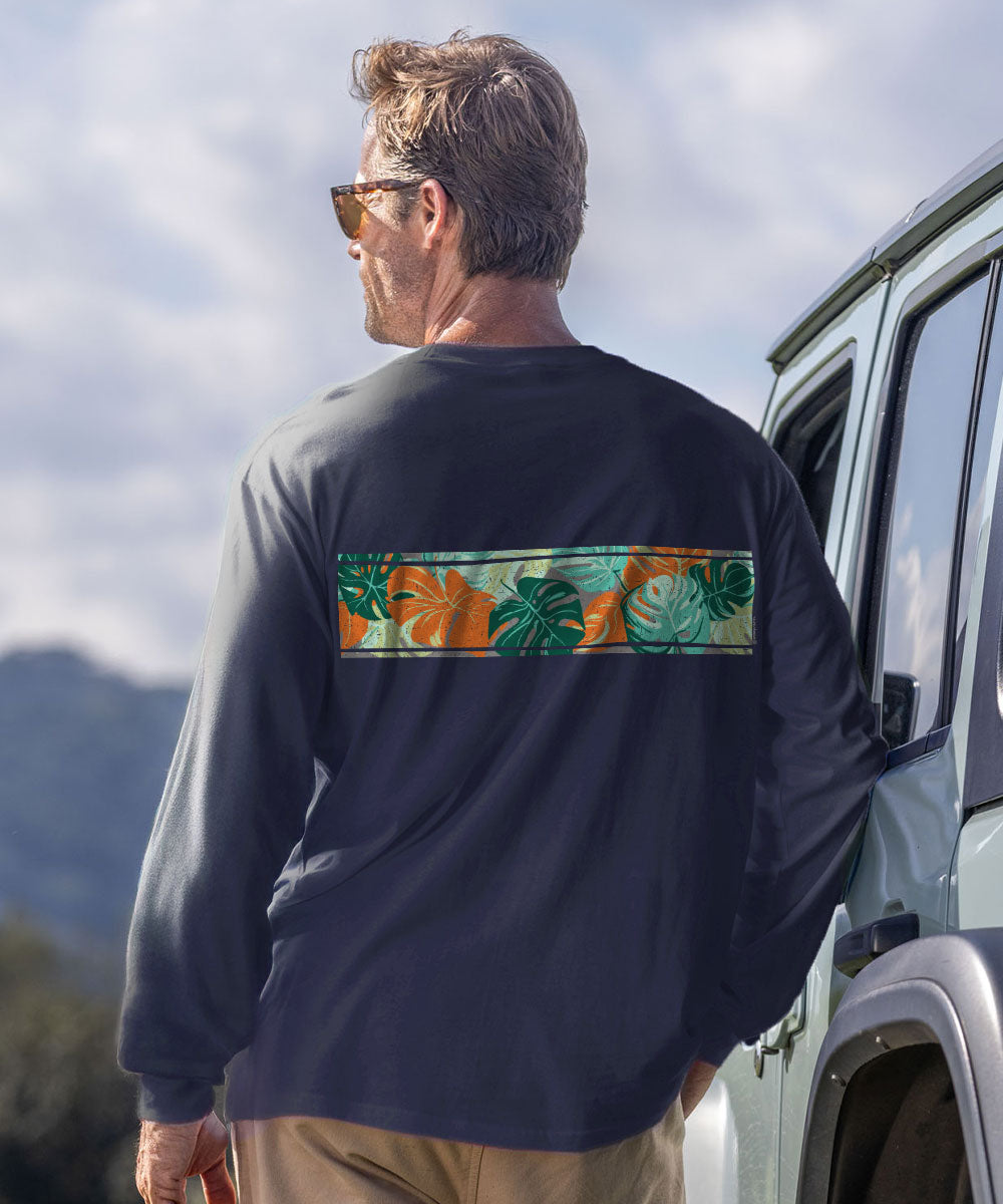 A man wearing a dark charcoal long-sleeve shirt with a horizontal tropical floral print band across the back, standing next to a vehicle outdoors. View 3