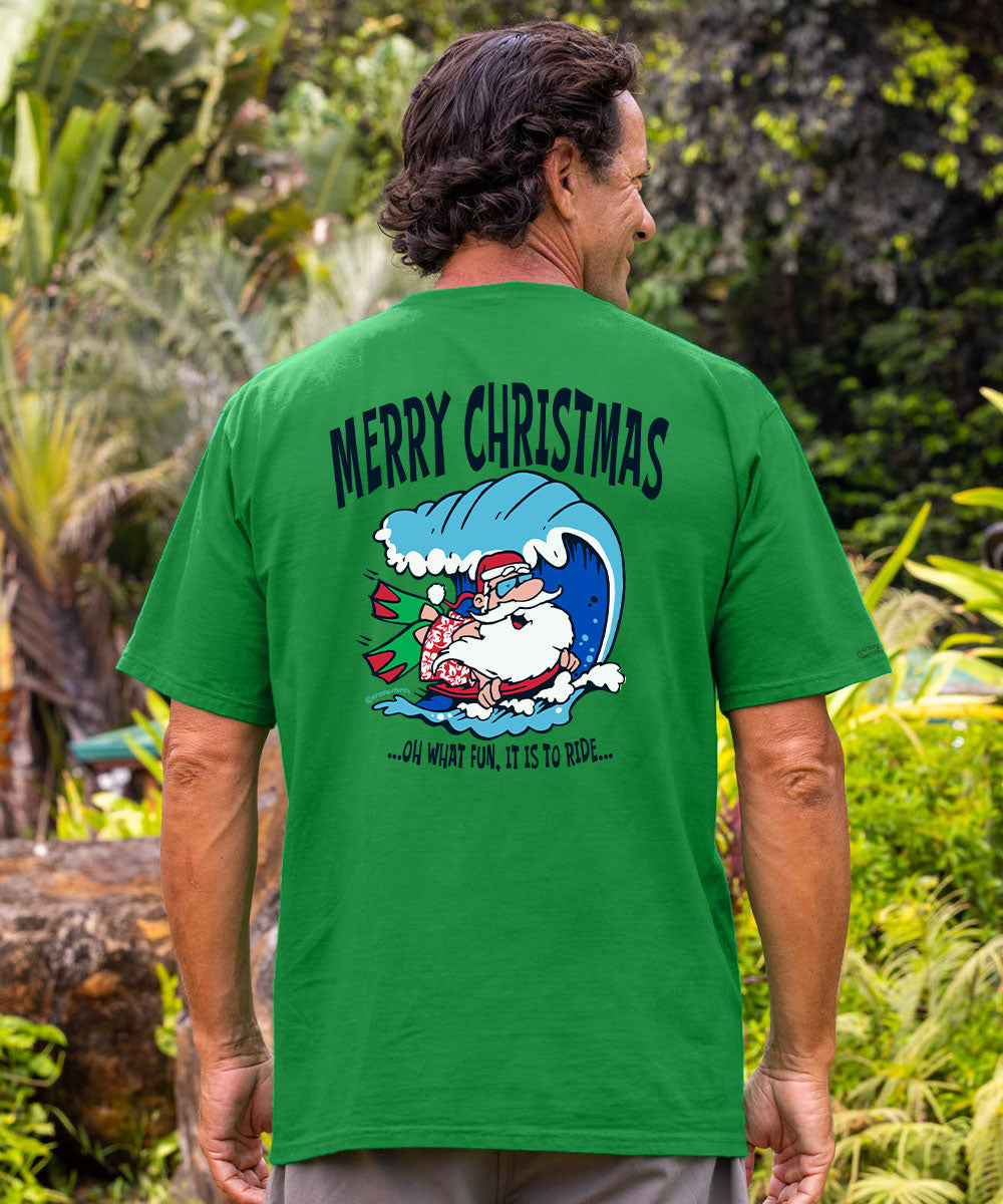 A man wearing a bright green t-shirt, viewed from behind, showing a large Christmas graphic on the back. The graphic features the text 'MERRY CHRISTMAS' above an illustration of Santa riding a blue wave with the phrase '. View 2