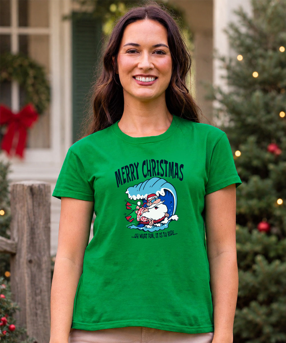A woman wearing a bright green graphic t-shirt with a Christmas Santa design and the text 'MERRY CHRISTMAS' and 'J'48TH BLESSING. View 2