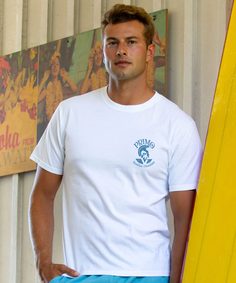 Man wearing a white t-shirt with a logo, standing in front of a colorful mural. View 3