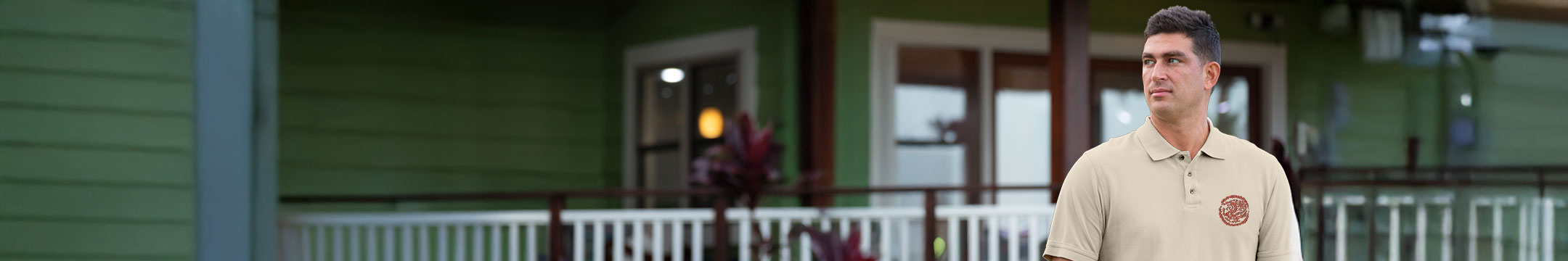 Man standing in front of a house with a green exterior