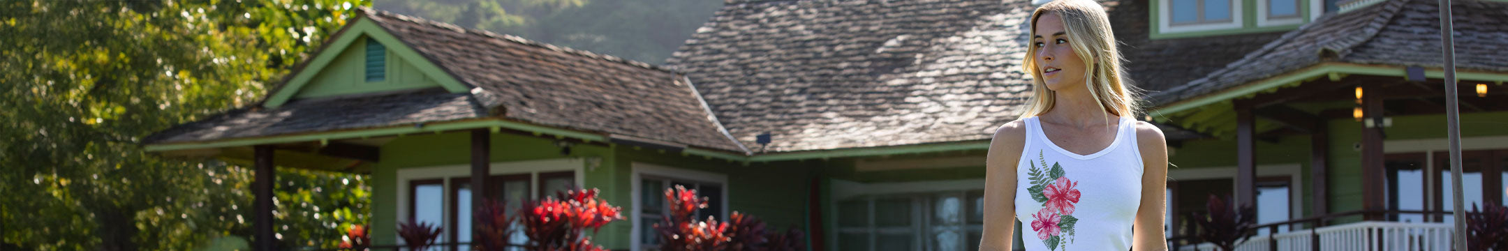 Woman standing in front of a house with a garden