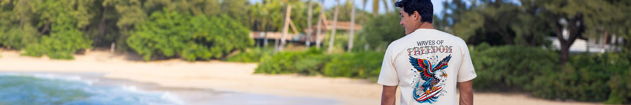 Man wearing a t-shirt with a graphic design on a beach