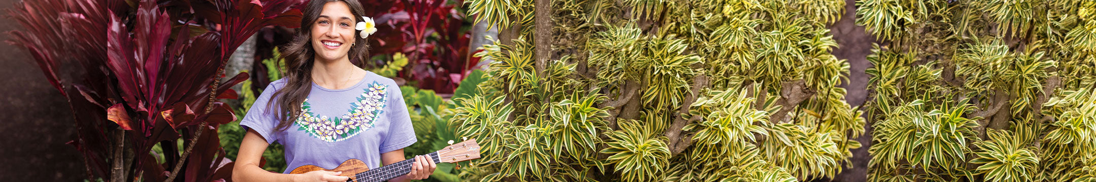 Woman playing a ukulele surrounded by lush greenery