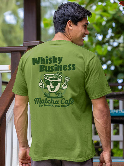 Person wearing a green t-shirt with 'Whisky Business Matcha Cafe' text and graphics.