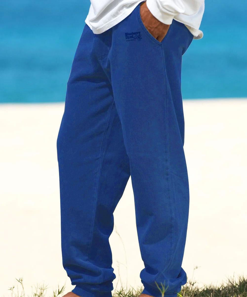 A person wearing blue pants at the beach View 2
