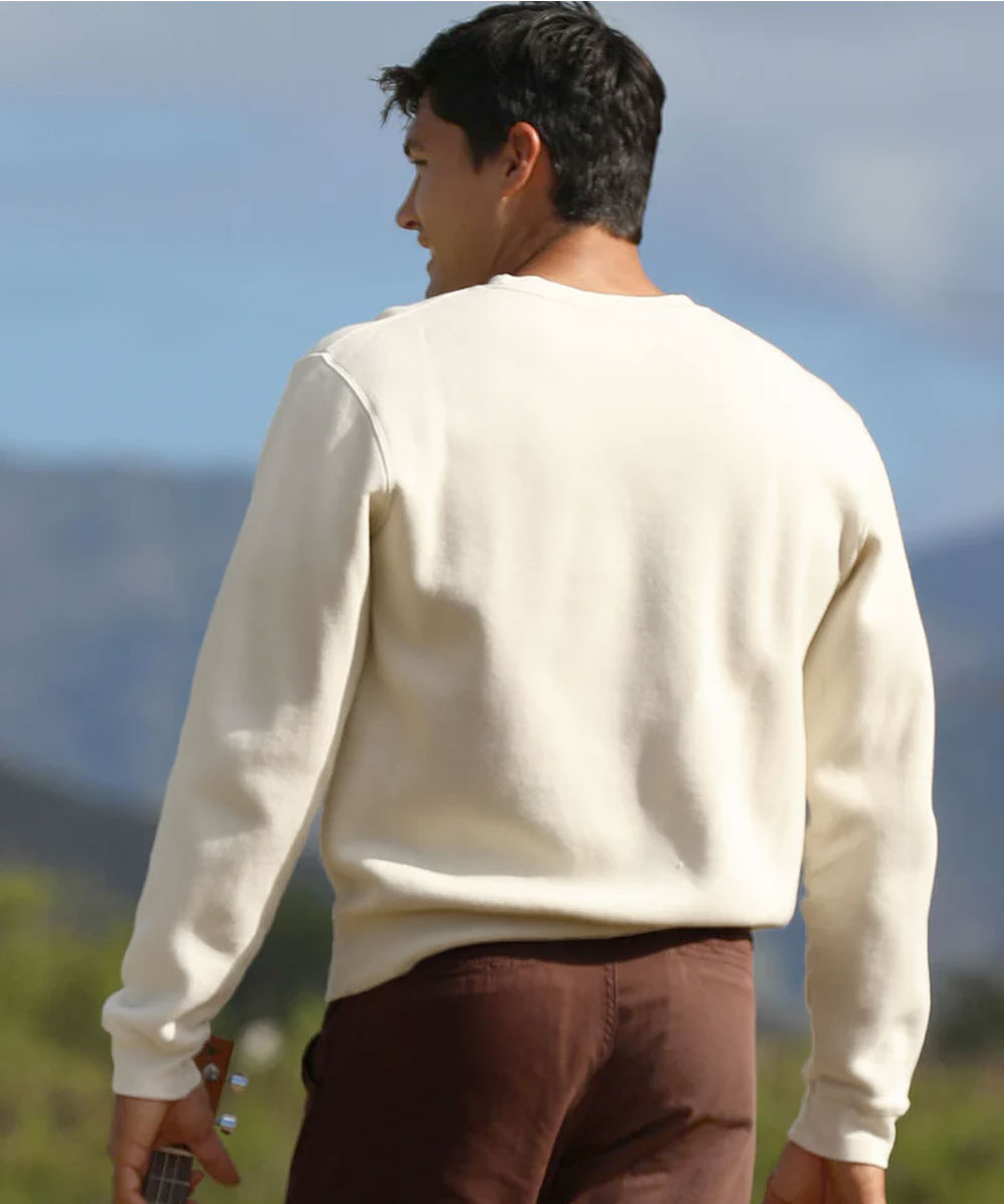Man holding ukulele wearing a light beige sweatshirt View 3