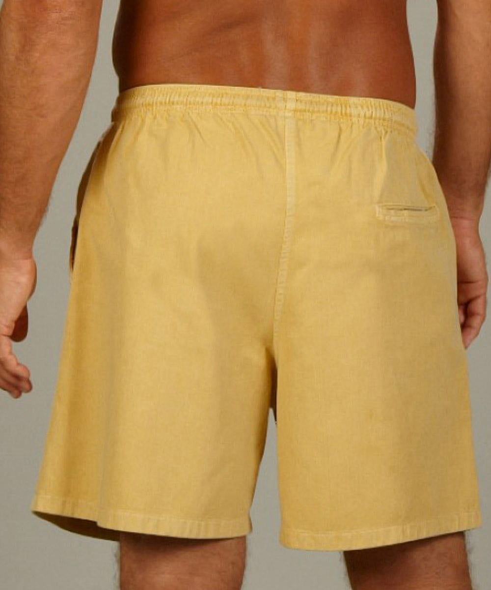 A person wearing yellow twill shorts with an elastic waistband. View 3