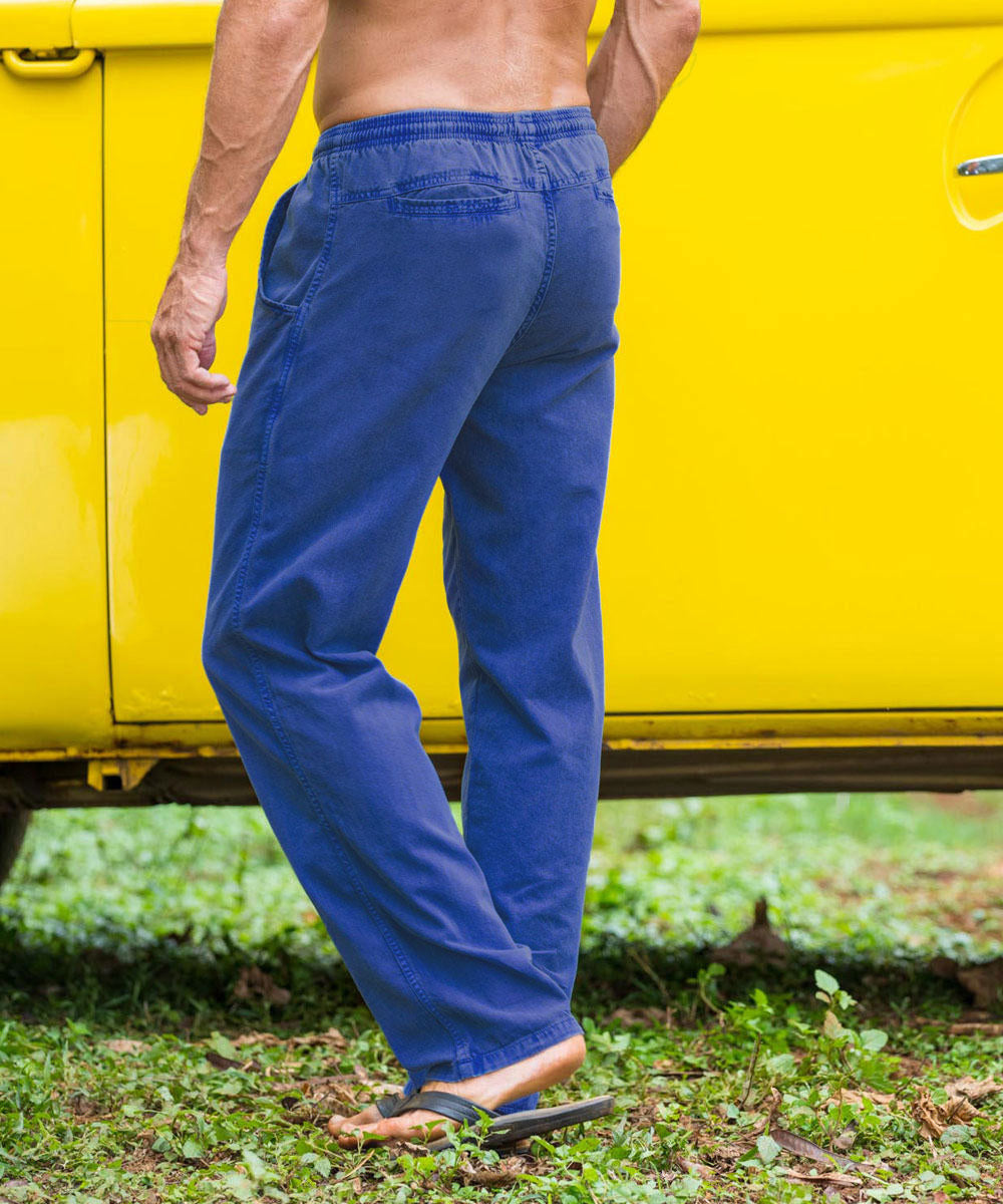 A person standing in front of a yellow vehicle wearing blue twill pants with an elastic drawstring waistband. View 3