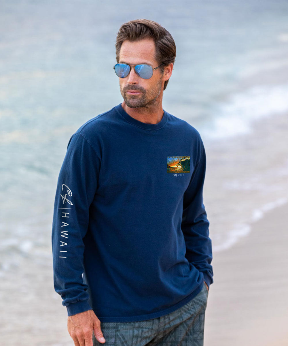 A man wearing a Navy long-sleeve shirt with Hawaii text on sleeve and scenic graphic on chest. View 3