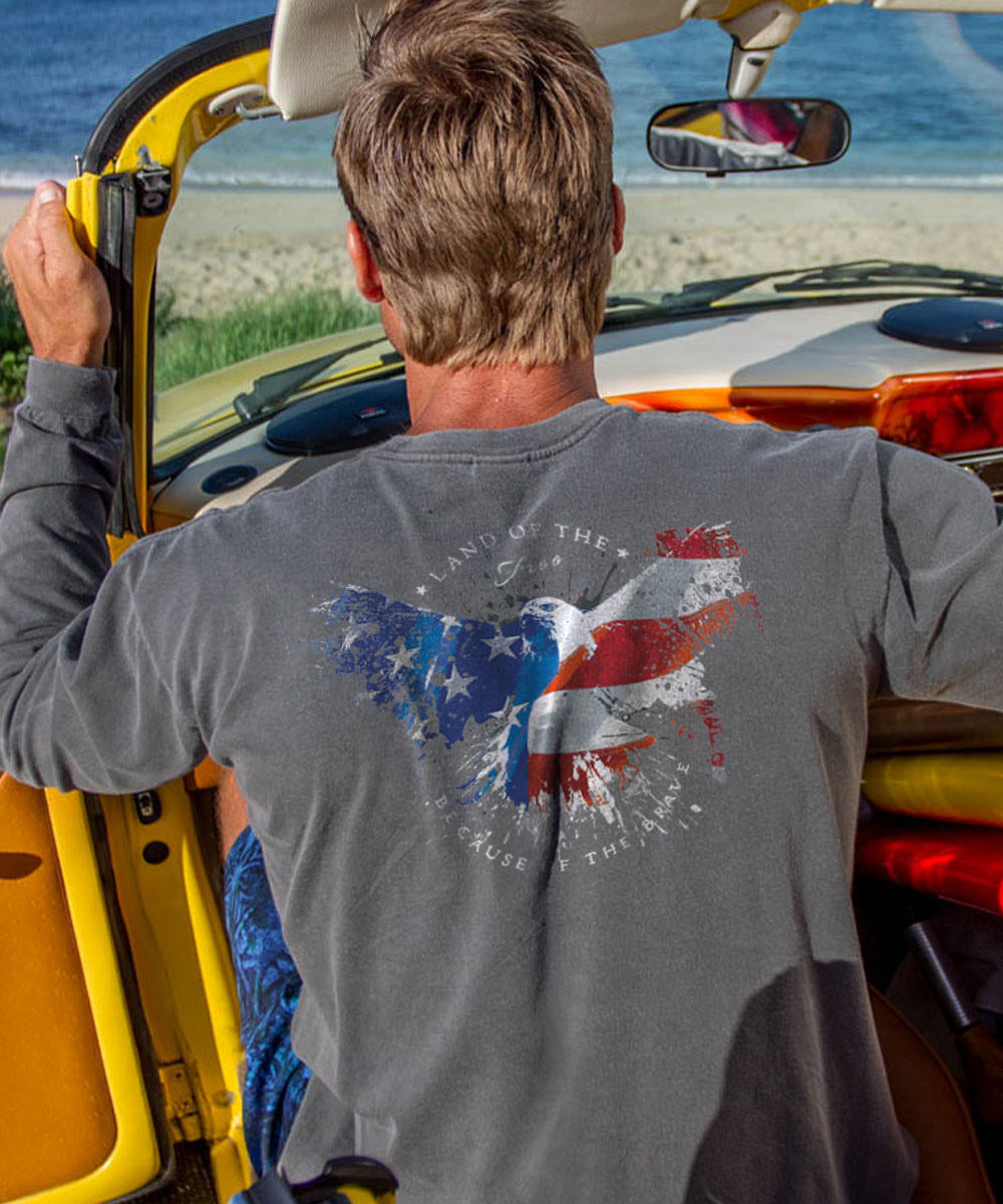 A person viewed from behind wearing a long sleeve crewneck t-shirt with a patriotic eagle design in red, white, and blue. View 2