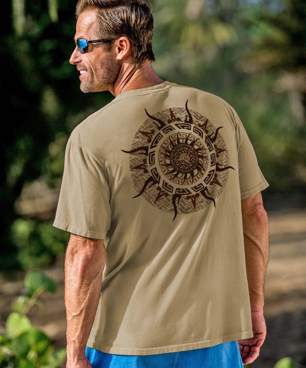 A person wearing a beige crewneck t-shirt with a sun spinner design in the center, standing outdoors. View 2