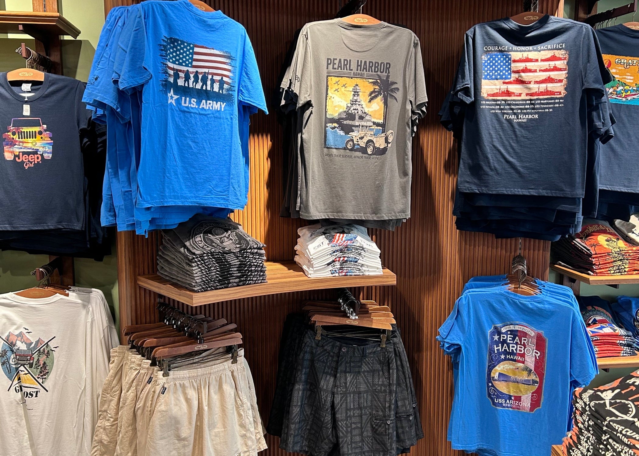 A wall in a retail store showing different Crazy Shirt tees and shorts