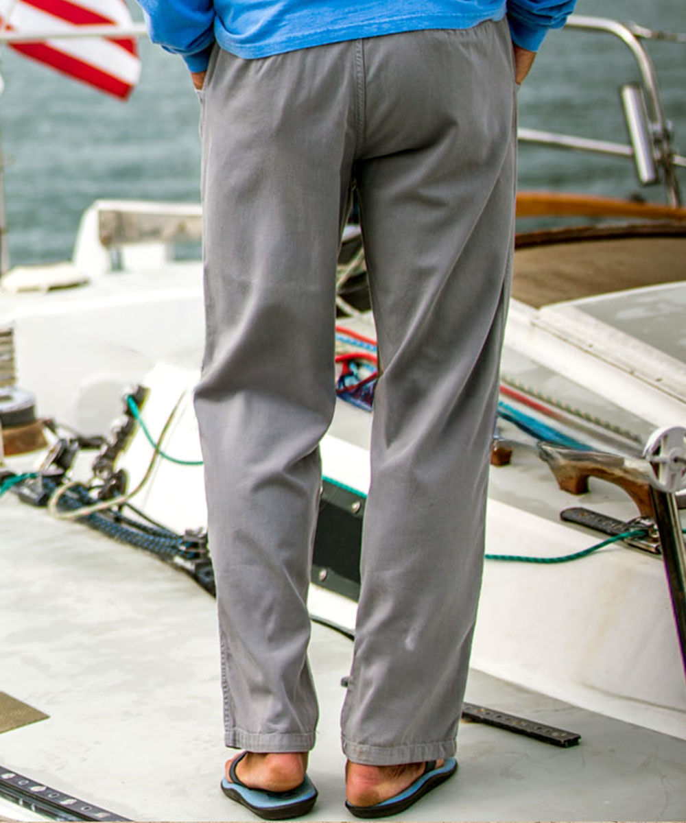A man standing on a boat wearing gray twill pants View 3