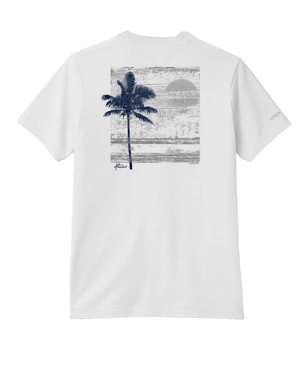 White short-sleeve t-shirt shown from the back, featuring a large graphic print of a dark blue palm tree against a textured gray and blue sunset beach scene. View 1