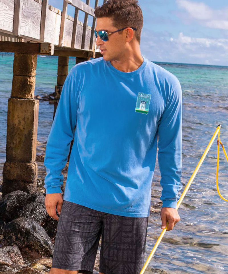Man wearing a blue long-sleeve shirt with a logo by the water View 3
