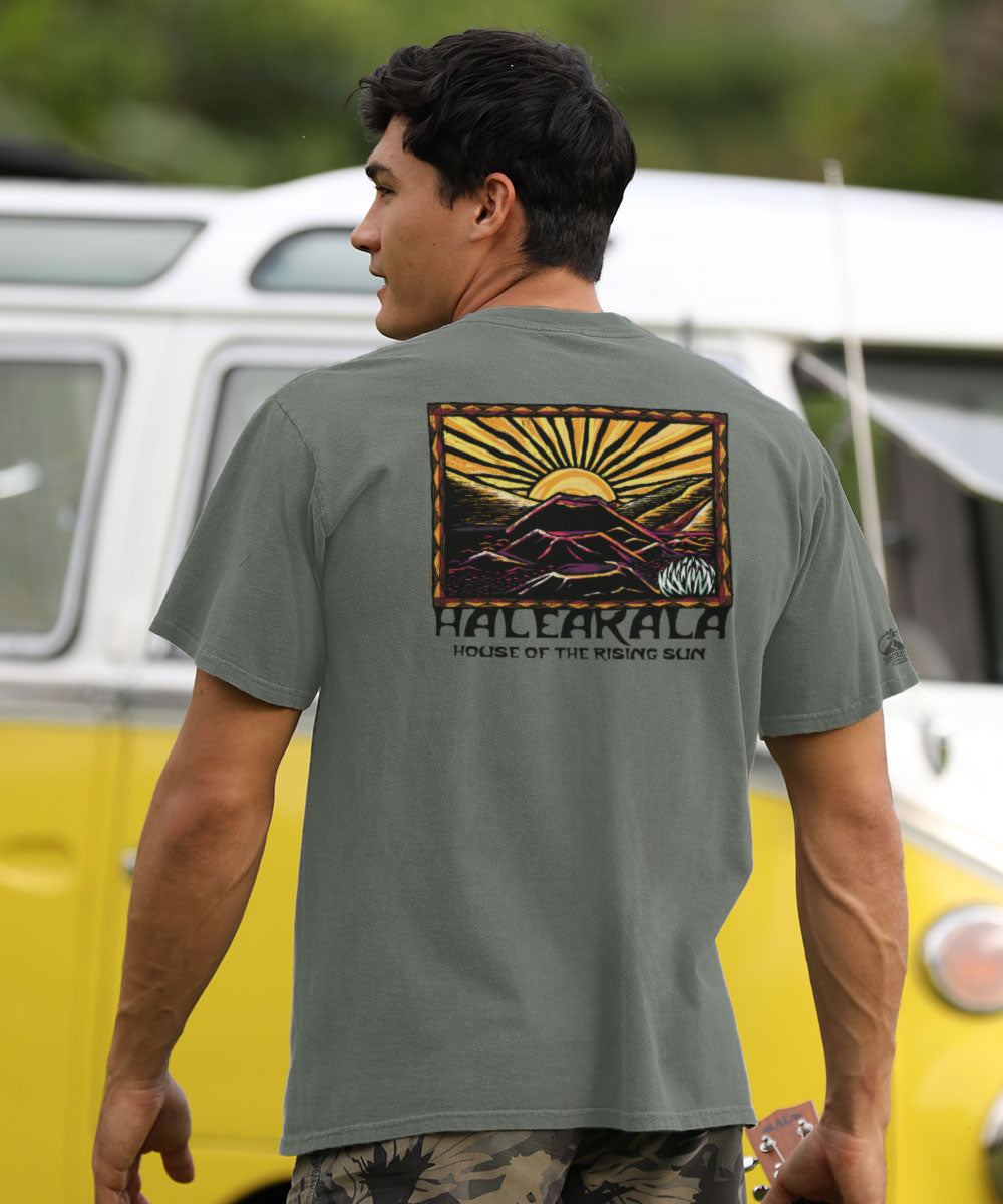 Man wearing a t-shirt with a graphic design in front of a vintage van. View 2