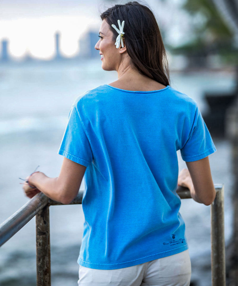 Woman wearing a blue t-shirt by a waterfront View 3