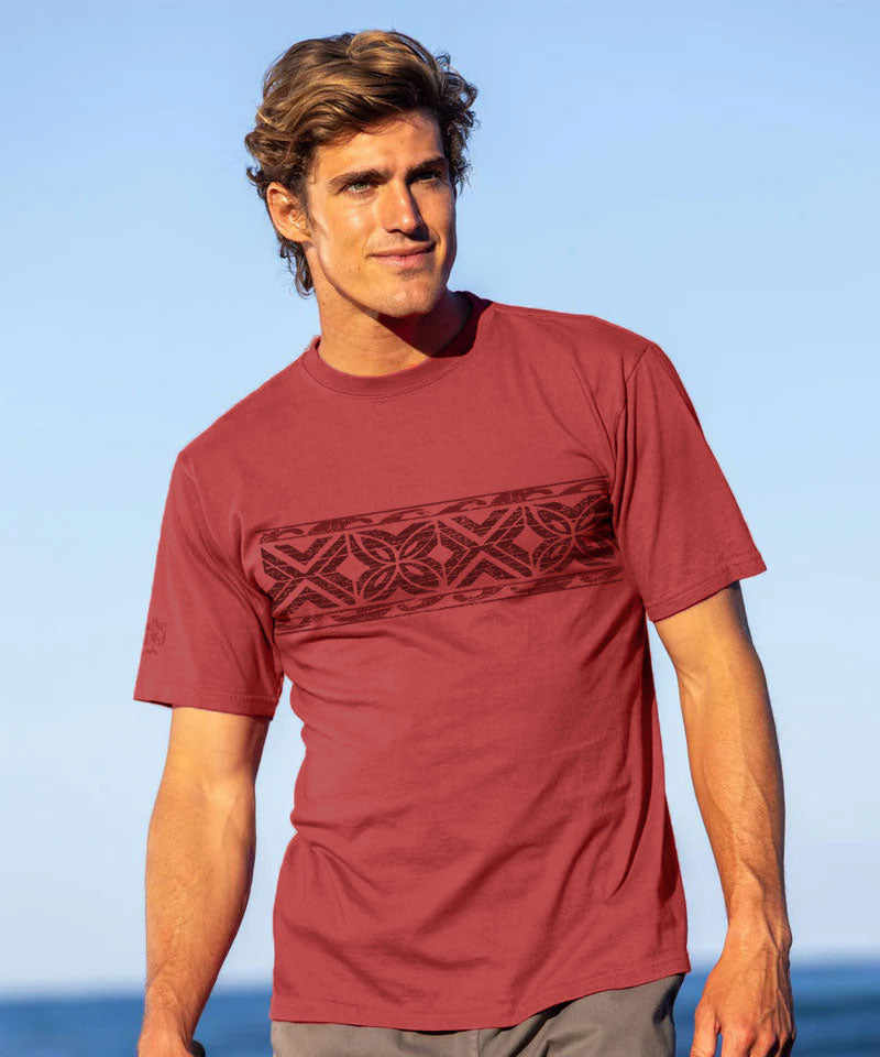 Man wearing red shirt standing on the beach View 2